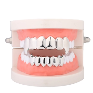 Macro shot of silver vampire fang grillz set on a realistic dental model display