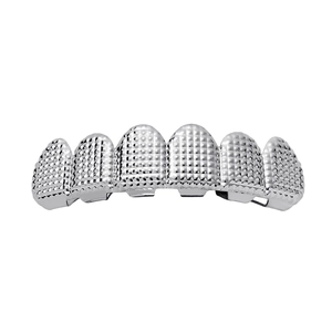 Detail of silver hip hop grillz with textured grid pattern and high metallic luster