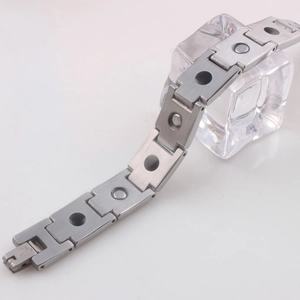 Brushed stainless steel magnetic health bracelet with black oil drip inserts on white back
