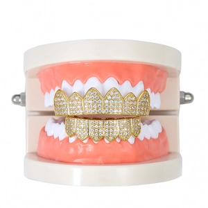 Hip hop micro-pave zircon gold grillz set with sharp fangs on a dental model base