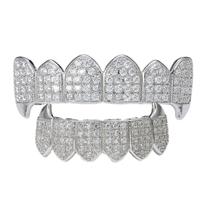 Macro detail of silver hip hop grillz set featuring micro-pave white zircon stones