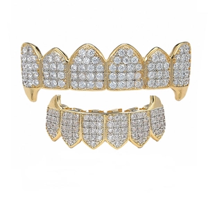 Detailed macro view of gold plated hip hop grillz set featuring sparkling zircon micro-paving