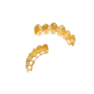 Macro detail of gold plated hip hop grillz set with pavé micro zircon stones