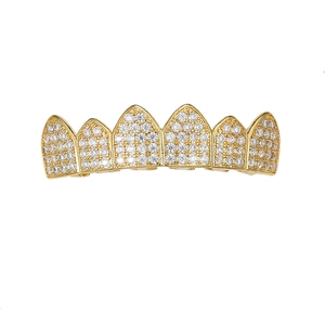 Detailed view of hip hop gold plated grillz with sparkling micro-paved white zircons