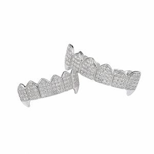 Detailed macro view of silver iced-out vampire grillz set with pavé cubic zirconia