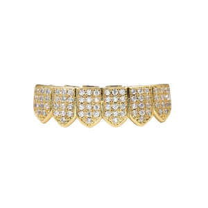 Macro detail of gold hip hop grillz featuring micro paved zircon crystals on six teeth