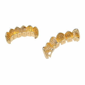 Close-up of iced out gold plated hip hop grillz set with sparkling white zircon stones