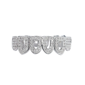 Détail de grillz hip-hop argentés avec pavage de zircons et motif d'étoile évidée