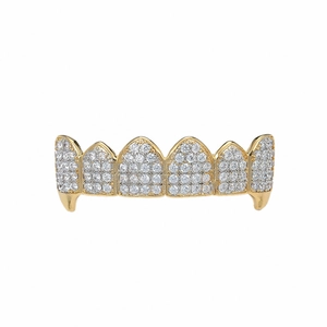 Macro detail of gold hip hop grillz with micro-paved zircons and vampire fangs style