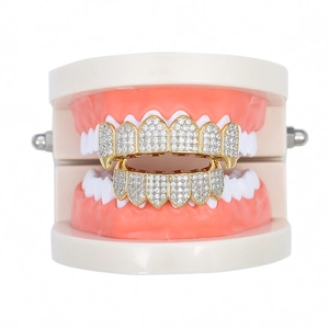 Iced out gold hip hop vampire grillz set with clear zircon stones on dental model