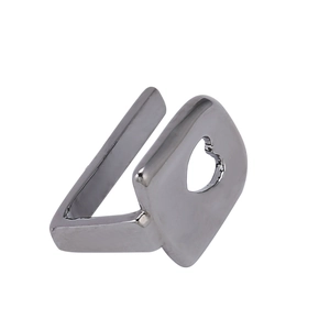 Macro shot of silver hip-hop grillz ring featuring a square plate and heart cutout detail