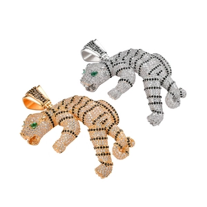 3D tiger head pendant with cubic zirconia pave and green eyes in gold and silver finish