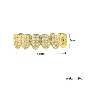 Detail view of gold hip hop grillz with white zircon inlay and embossed portrait design
