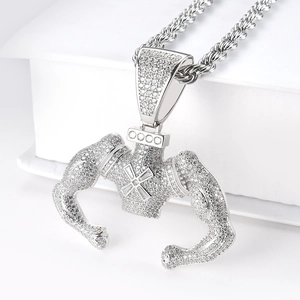 Macro shot of silver hip hop muscle man pendant with cubic zirconia and rope chain