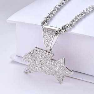 Detail of hip-hop number 47 star pendant with pavé cubic zirconia on a rope chain