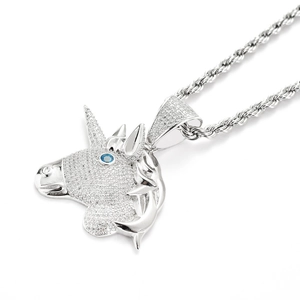 Detailed close-up of a silver unicorn pendant with micro-pave zircons and blue eye