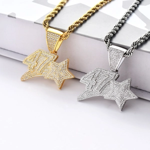 Macro detail of iced-out number 47 and star pendant with cubic zirconia on rope chain