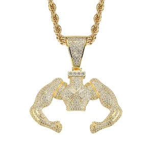 Iced out muscular body builder pendant necklace with sparkling zircons on gold rope chain
