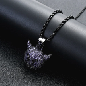 Détail macro du pendentif petit démon hip-hop avec zircons violets sur chaîne noire