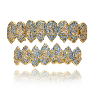 Hip Hop Vampir Zähne Grillz Set mit blau-weißen Zirkonsteinen auf Goldbasis