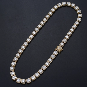 Close-up of golden tennis chain with square-cut cubic zirconia and secure box clasp detail