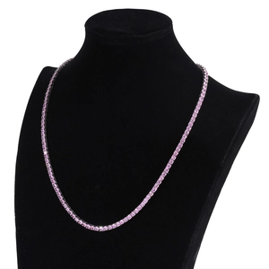 Macro view of 4mm pink zircon tennis necklace on black mannequin with dark metal plating