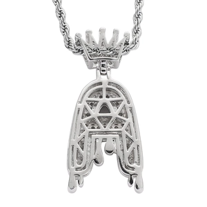 Macro detail of silver hip hop letter A crown pendant with textured hollow back and rope chain