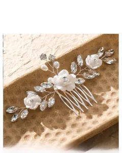 Detailed macro view of handmade bridal hair comb with resin roses, pearls, and rhinestones