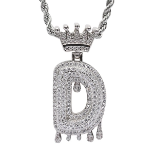 Macro shot of silver hip-hop letter D pendant with crown and dripping effect
