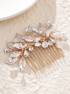 Detail of bridal hair comb with gold alloy leaves and sparkling crystal rhinestones
