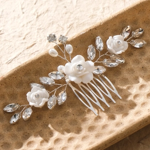 Elegant bridal hair comb with white resin roses, rhinestones and pearls on silver wire