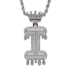 Close-up of iced out silver letter I pendant with crown and melting drip effect