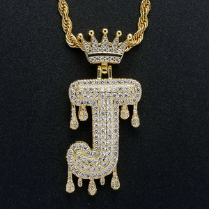 Macro shot of hip hop J letter pendant with crown and white zircons on rope chain