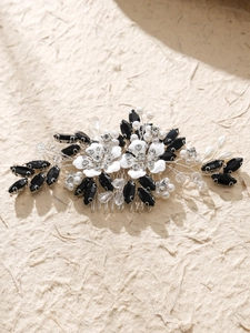 Detail view of handmade bridal hair comb with black gems and white lacquer flowers