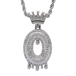 Macro shot of silver hip hop crown pendant featuring zircon inlay and melting water drop effect