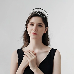 Détail du serre-tête de mariée en maille noire tissée main avec perles blanches élégantes