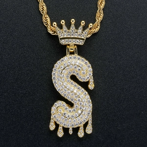 Macro shot of iced out gold crown and dripping letter S hip hop pendant with rope chain