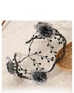Detailed view of handmade black beads and delicate floral accents on a vintage bridal headband