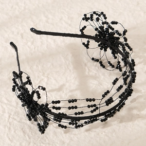 Detail of handcrafted black beaded floral headband with intricate faceted beadwork