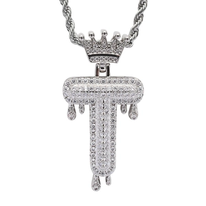 Detail of hip hop letter T pendant with crown and dripping water effect in silver