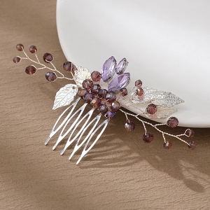 Detail view of handmade purple rhinestone bridal hair comb with floral silver vine accents