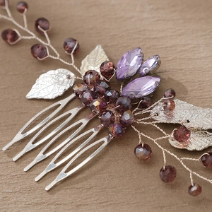 Detail of silver bridal hair comb with purple gemstones and handmade beadwork detailing