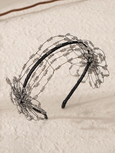 Macro shot of handcrafted bridal headband with grey beads and 3D floral metal wire details