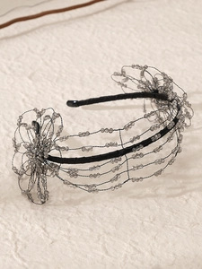 Detail of handcrafted beaded headband with grey crystal flowers and black woven wire