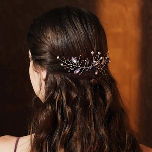 Detailed macro view of handmade bridal hair comb with purple crystals and rhinestones