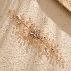 Detail of rose gold bridal hair comb with champagne crystals and leaf rhinestones