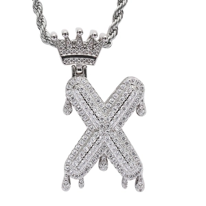 Close-up of hip hop crown pendant with dripping X letter and micro-set cubic zirconia stones