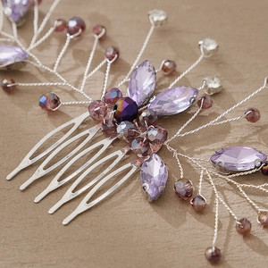 Macro shot of handmade purple crystal bridal hair comb with intricate silver wire weaving