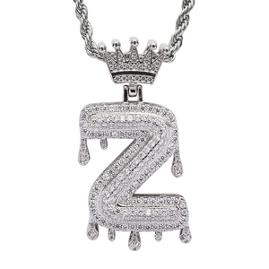Macro view of silver hip-hop letter Z pendant with crown and dripping water design