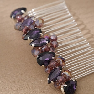 Macro detail of bridal hair comb with purple crystals and champagne beads on wood